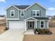 Two-story house, gray siding, attached garage, and a welcoming porch at 233 John Stark Dr, Fuquay Varina, NC 27526