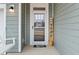 Inviting front entry with porch swing and 'Home' decor at 233 John Stark Dr, Fuquay Varina, NC 27526