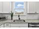 Kitchen boasts granite countertops, white cabinets and a stainless steel sink at 233 John Stark Dr, Fuquay Varina, NC 27526