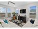 Bright living room with comfy sofas, large TV, and lots of natural light at 233 John Stark Dr, Fuquay Varina, NC 27526