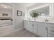 Modern bathroom with double vanity and a large mirror at 2510 Harvard Ave, Durham, NC 27703