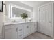 Bathroom with double vanity, lighted mirror, and modern fixtures at 2510 Harvard Ave, Durham, NC 27703