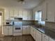 White kitchen features granite countertops and a full suite of appliances at 2690 Polenta Rd, Clayton, NC 27520