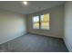 Bright bedroom with neutral carpeting and two large windows at 289 Magnolia Run Way, Benson, NC 27504