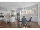 Eat-in kitchen with island and glass-top dining table at 312 Lucky Ribbon Ln, Holly Springs, NC 27540