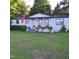 Charming brick home with a welcoming front porch, showcasing a well-maintained lawn and inviting curb appeal at 3259 Us 421, Lillington, NC 27546