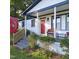 Inviting front porch with wicker seating and freshly painted white brick exterior at 3259 Us 421, Lillington, NC 27546