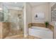 Spa-like bathroom with soaking tub and glass shower enclosure at 332 Karpen Ln, Cary, NC 27519