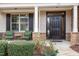 Inviting front porch with stone accents and comfortable seating at 332 Karpen Ln, Cary, NC 27519