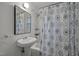 Simple bathroom with white pedestal sink and shower at 3411 Octavia St, Raleigh, NC 27606