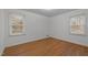 Bedroom with hardwood floors and two windows at 3411 Octavia St, Raleigh, NC 27606