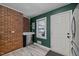 Kitchen with exposed brick, stainless steel appliances and white door at 3411 Octavia St, Raleigh, NC 27606