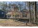 Tan house with white trim and porch, nestled in a wooded area at 356 Harbor Trace, Sanford, NC 27332