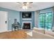 Living room with fireplace, large TV, and access to balcony at 3702 Chimney Ridge Pl # 03, Durham, NC 27713