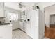 White kitchen with gas stove, white cabinets and tile floor at 3726 Randolph Rd, Durham, NC 27705