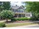 Two-story house with gray siding, stone accents, and a large front porch at 404 Stearns Way, Wake Forest, NC 27587