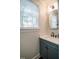 Powder room with a modern vanity and an oval mirror at 404 Stearns Way, Wake Forest, NC 27587