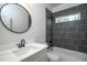 Modern bathroom with white vanity, marble countertop, and grey tile shower at 4120 Emily Ln, Oxford, NC 27565