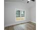 Bright bedroom with vaulted ceiling, large window, and wood-look flooring at 4120 Emily Ln, Oxford, NC 27565