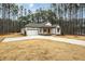 White farmhouse exterior with a large driveway and mature trees at 4120 Emily Ln, Oxford, NC 27565