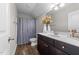 Clean bathroom with dark vanity and gray shower curtain at 430 Heart Pine Dr, Wendell, NC 27591
