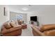 Spacious bonus room with leather furniture and large TV at 430 Heart Pine Dr, Wendell, NC 27591