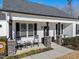 Front porch with rocking chairs and stone pillars at 430 Heart Pine Dr, Wendell, NC 27591