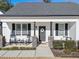 Charming front porch with rocking chairs and stone pillars at 430 Heart Pine Dr, Wendell, NC 27591