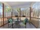 Relaxing screened porch with wooden furniture and wooded views at 430 Heart Pine Dr, Wendell, NC 27591