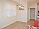 Bright dining area with light hardwood floors and a modern chandelier at 60 Buttonwood Ct, Youngsville, NC 27596