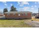 Back of brick ranch home, showing a yard and shed at 630 Holly St, Burlington, NC 27217