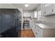 Small kitchen with white cabinets and stainless steel stove at 630 Holly St, Burlington, NC 27217