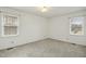 Well-lit bedroom featuring neutral walls and carpeting at 6916 Bill Poole Rd, Rougemont, NC 27572