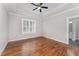 Bright bedroom featuring hardwood floors and a ceiling fan at 95 Somerset Ln, Henderson, NC 27537