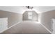 Spacious attic featuring neutral carpeting and walls and access doors for storage at 109 Stoneline Ct, Holly Springs, NC 27540