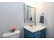 Charming bathroom features blue vanity, decorative mirror, and accent decor for a stylish touch at 109 Stoneline Ct, Holly Springs, NC 27540