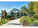 Landscaped community clubhouse with sidewalks and a view of the lake at 109 Stoneline Ct, Holly Springs, NC 27540