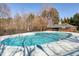 Community pool with crystal clear water surrounded by lounge chairs and a bath house at 109 Stoneline Ct, Holly Springs, NC 27540