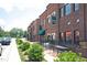 Charming brick retail buildings feature tables and awnings on tree-lined street at 109 Stoneline Ct, Holly Springs, NC 27540