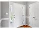 Entryway featuring a white front door with sidelights and a coat closet at 109 Stoneline Ct, Holly Springs, NC 27540