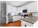 Modern kitchen featuring stainless steel appliances and granite countertops at 109 Stoneline Ct, Holly Springs, NC 27540