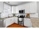 Modern kitchen with stainless steel appliances and granite countertops at 109 Stoneline Ct, Holly Springs, NC 27540