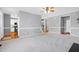 View of the living room showcases an open floor plan with the kitchen, stairs, and doorways nearby at 109 Stoneline Ct, Holly Springs, NC 27540
