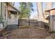 Gravel backyard with mature trees and small fence at 1105 W Lenoir St, Raleigh, NC 27603