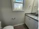 Bathroom with granite countertop, white cabinets and a toilet at 171 Wynd Crest Way, Benson, NC 27504