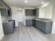 Modern kitchen with gray cabinets, granite countertops, and stainless steel appliances at 171 Wynd Crest Way, Benson, NC 27504