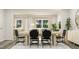 Bright dining room with a wood table and black chairs, overlooking the living room at 1848 Poe Farm Ave, Apex, NC 27502
