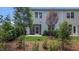Landscaped backyard with screened porch and young trees at 1878 Sweet Gardenia Way, Apex, NC 27502
