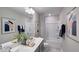 Clean bathroom with double vanity and shower/tub combo at 1878 Sweet Gardenia Way, Apex, NC 27502