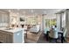 Bright dining area with table and chairs near kitchen and living room at 1878 Sweet Gardenia Way, Apex, NC 27502
